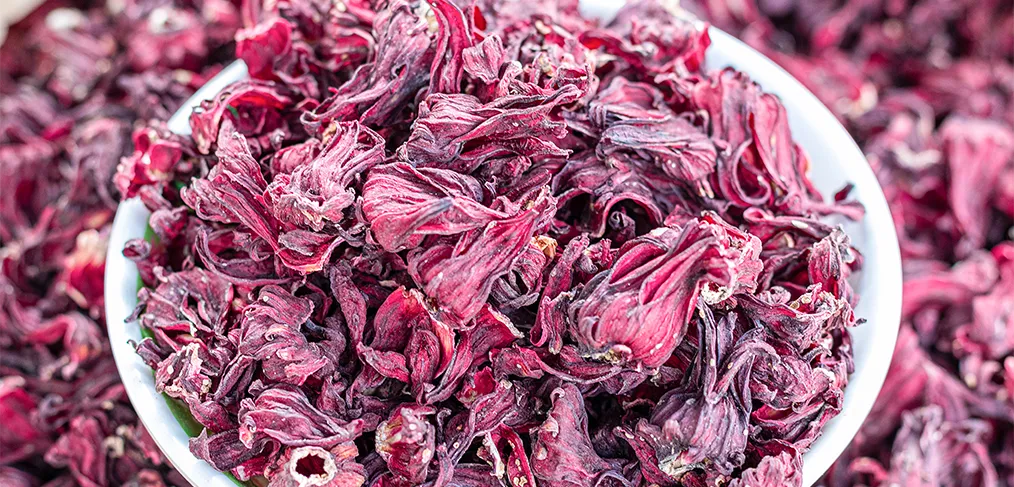 A bowl of dried deep-red hibiscus flowers